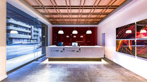 a lobby with a reception desk in a building at The Kanzashi Tokyo Asakusa in Tokyo