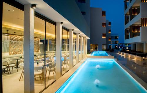 a swimming pool in a hotel with a restaurant at AKASHA Beach Hotel & Spa in Hersonissos