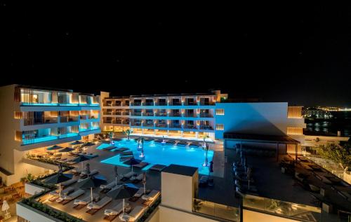 an aerial view of a hotel with a pool at night at AKASHA Beach Hotel & Spa in Hersonissos