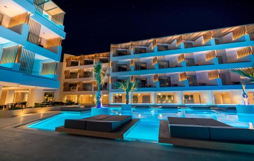a hotel with a swimming pool at night at AKASHA Beach Hotel & Spa in Hersonissos