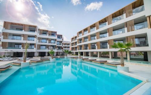 a swimming pool in front of a building at AKASHA Beach Hotel & Spa in Hersonissos