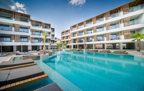 a swimming pool in front of a building at AKASHA Beach Hotel & Spa in Hersonissos