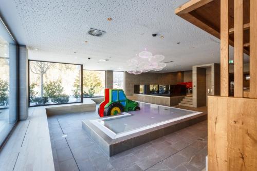 a living room with a childs toy in the middle at Rieser Achensee Resort in Pertisau