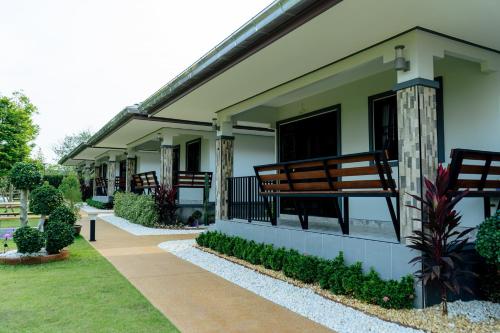 a building with a bench on the side of it at Thai Smile Resort in Rayong