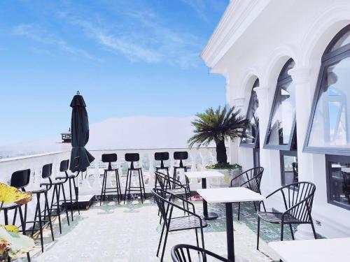 a row of tables and chairs on a balcony at Hotel Hoa Nắng in Bao Loc
