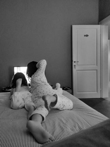 two babies laying on a bed in diapers at Villa Niccoli in Castelfiorentino