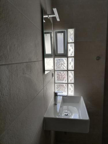 a bathroom with a sink and a window at Carpe Diem Ierissos in Ierissos