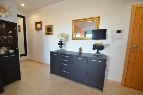 a room with a dresser with a mirror on the wall at Marina Vilamoura Aquamar 301 By Vilamoura Sun in Vilamoura