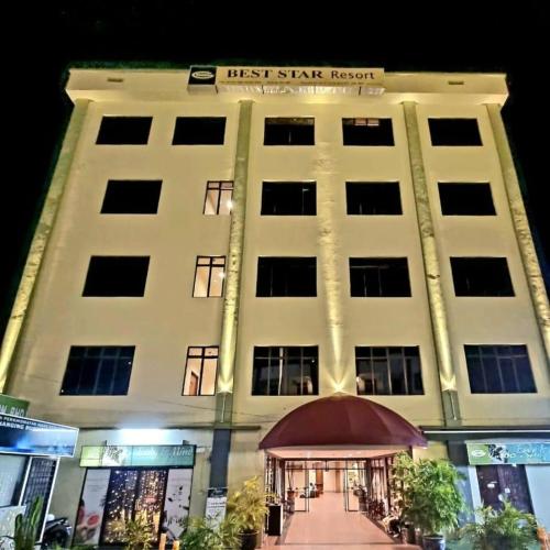 a large white building with a first star hotel at Best Star Resort in Pantai Cenang