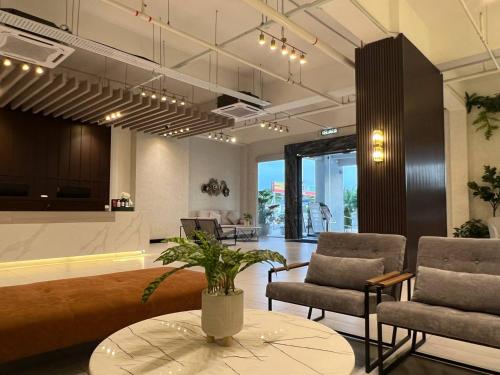 a living room with two chairs and a table at FUHOTEL in Bukit Mertajam