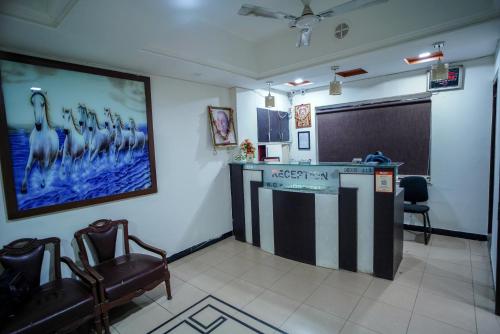 a waiting room with a large picture on the wall at Hotel Sadbhav in Ahmedabad