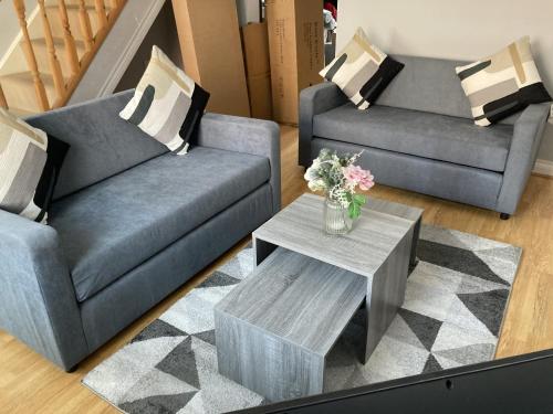 a living room with two couches and a coffee table at Newbourne Terrace in Derby