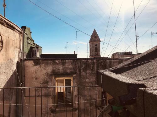 an old building with a clock tower in the background at B&B Via dell'Azzurra in Bari