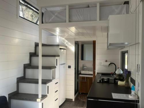 a kitchen with a staircase in a tiny house at Lovin Göcek & Tiny House Lykia in Kertmeç