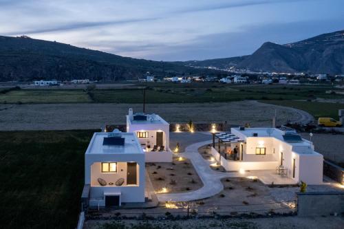 an aerial view of a house at night with lights at Almira Luxury Suites in Perivolos