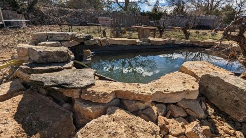 a small pool of water with rocks around it at Gite Bardelle in Orgnac-lʼAven