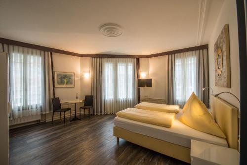 a hotel room with a bed and a desk at Hotel Scheffelhof in Konstanz