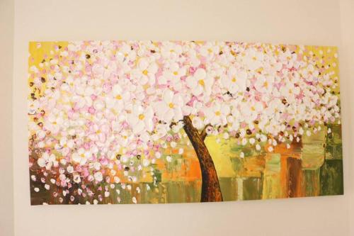 a painting of a tree with pink and white flowers at 西日置 一軒家 rashiku in Nagoya