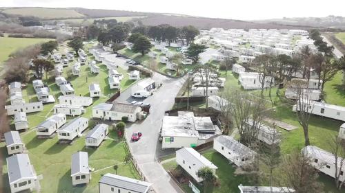 an aerial view of a village with white houses at Newquay Bay Resort 181 in Newquay Bay Resort