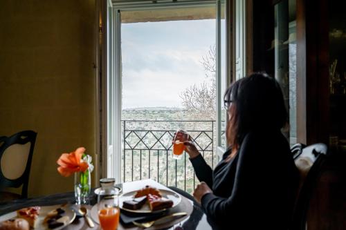 a woman sitting at a table with a plate of food at L'Antica Conceria in Matera
