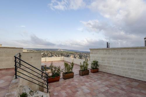 a patio with potted plants on top of a building at L'Antica Conceria in Matera