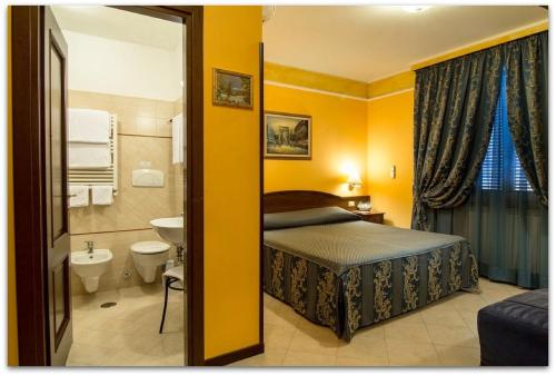 a hotel room with a bed and a bathroom at B&B Degli Amici in Ciampino