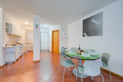 uma cozinha e uma sala de jantar com mesa e cadeiras em Casa Karin - Happy Rentals em Riva del Garda