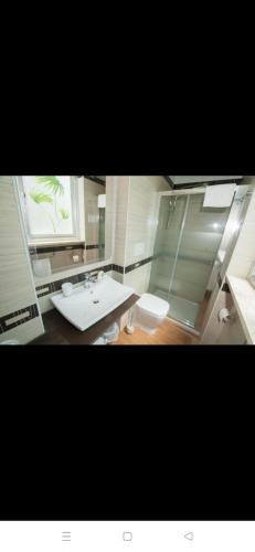 a bathroom with a sink and a toilet and a window at Family House in Lecce