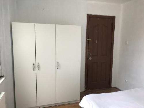 een slaapkamer met witte kasten en een bed bij Guest Apartment in Ganja
