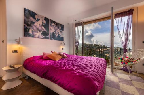 a bedroom with a purple bed and a large window at Villa Meridiana luxury property in Camogli in Camogli