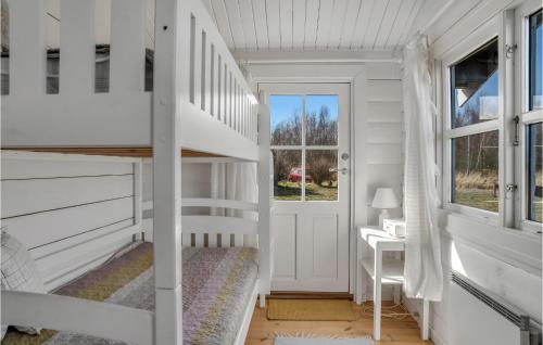 a white bedroom with a bunk bed and a desk at Cozy Home In Rdby With Kitchen in Rødby