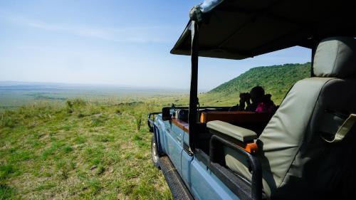 a group of people riding in a vehicle on a hill at Mara Elatia Camp in Masai Mara
