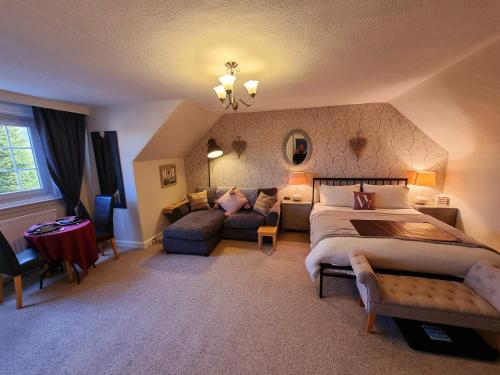 a bedroom with a large bed and a couch at Westcot in Callander