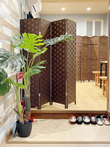 a room with a glass door with a potted plant at 距离Namba Shinsaibashi麗子民宿 in Osaka