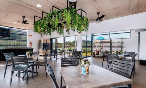 a restaurant with tables and chairs and a chandelier at Ballito Village Luxury Apartments in Ballito