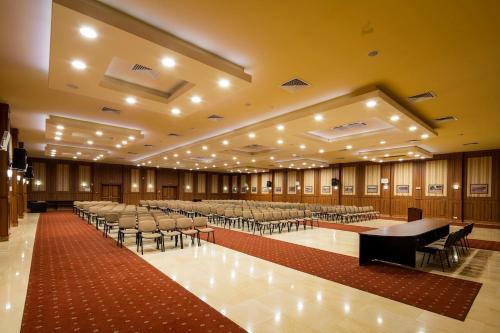 a large room with rows of tables and chairs at Admiral Hotel - Ultra All Inclusive & Private Beach in Golden Sands