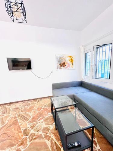 a living room with a couch and a table at sky inn with wonderful Acropolis view in Neos kosmos in Athens