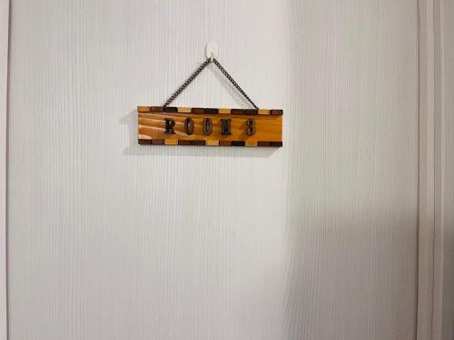 a wooden sign hanging on a white wall at 池袋Apila in Tokyo