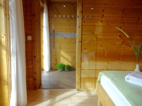 um quarto com uma parede de madeira e uma cama. em MEB Appartement em Blaichach