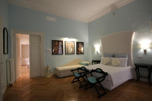 a bedroom with a bed and two chairs in it at Residenza L'angolo di Verona in Verona