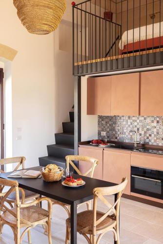 a kitchen and dining room with a table and chairs at Masseria Specchiulla in Otranto