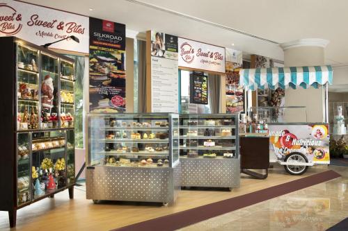 a bakery with a display of food in a store at Hotel Ciputra Jakarta managed by Swiss-Belhotel International in Jakarta