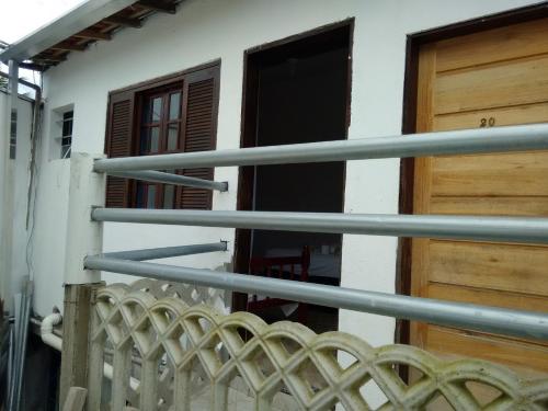 an open door of a building with a balcony at Pousada Edson in Caraguatatuba