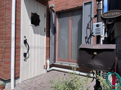 a front door of a house with a window at 池袋Apila in Tokyo