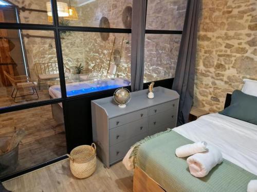 1 dormitorio con 1 cama y baño con bañera en Gîte « domaine de l’oustal nau », en Peyriac-de-Mer