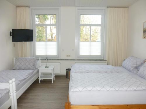 a bedroom with a bed and a couch and windows at Ferienwohnung Plett in Barlt