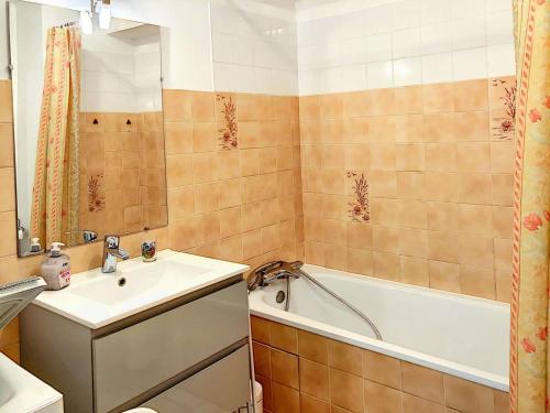 a bathroom with a sink and a tub and a toilet at Appartement 3 étoiles avec Wifi à Perros-Guirec - FR-1-542-42 in Perros-Guirec