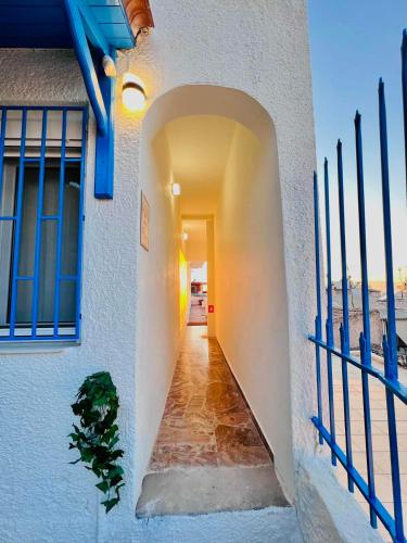 a hallway of a house with a blue gate at sky inn with wonderful Acropolis view in Neos kosmos in Athens