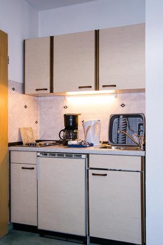 a kitchen with a stove and a counter top at Ferienwohnung Alpennelke in Füssen
