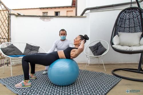 a woman doing exercises on an exercise ball at Boutique Apartment Eleganza in Chiusi